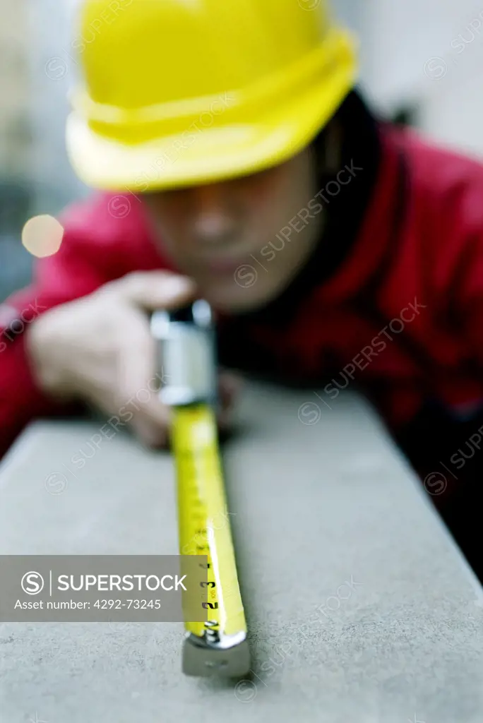 Worker taking size