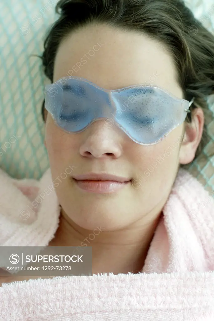 Woman lying in bed with mask on eyes