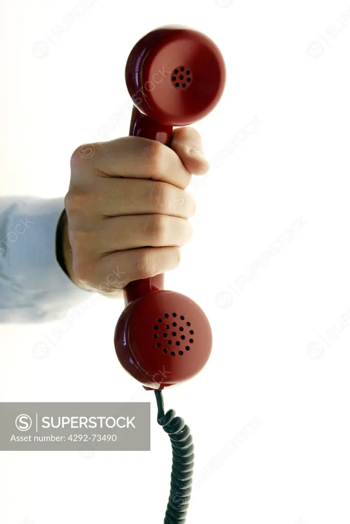 Hand holding telephone receiver