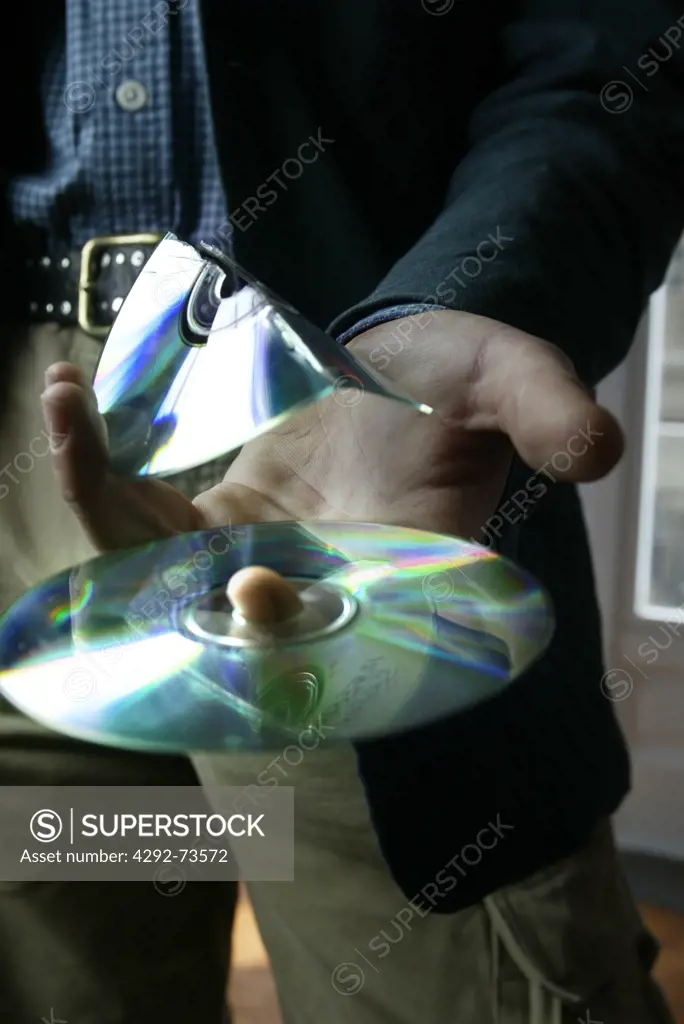 Hand with compact discs