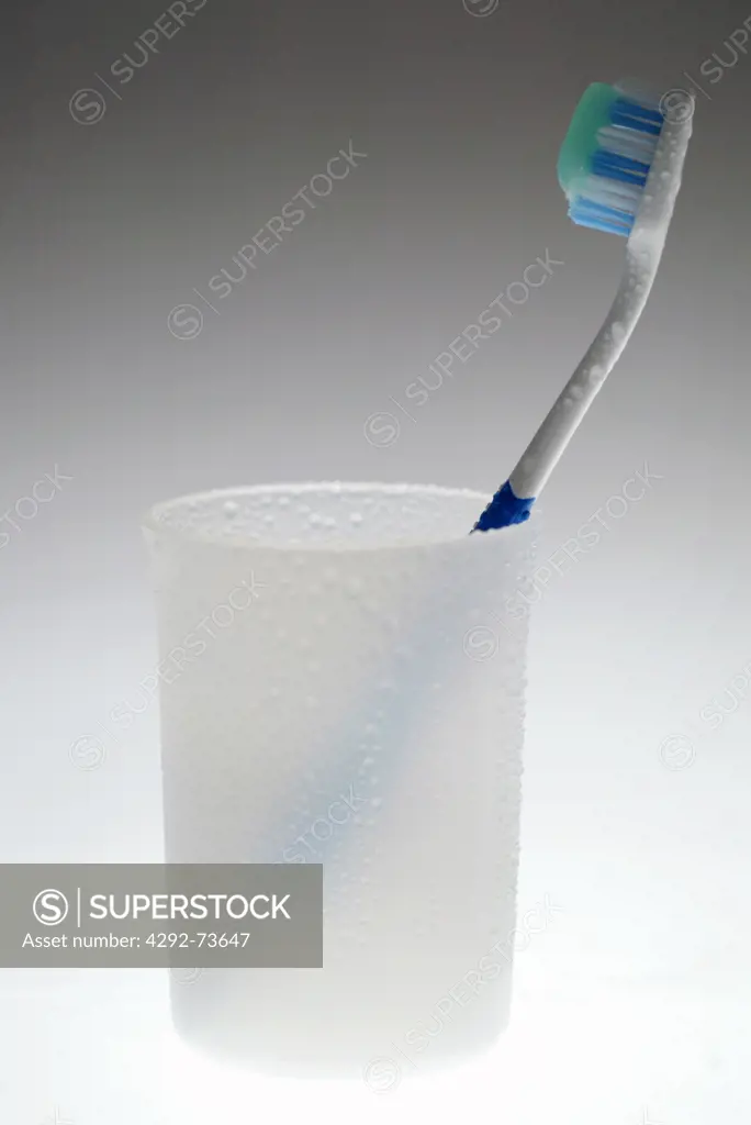 Toothbrush with plastic cup