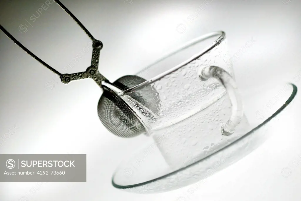 A glass cup with a tea strainer