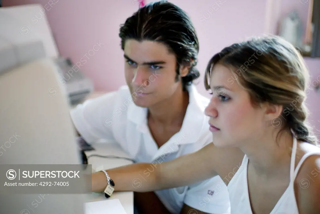 Teenage couple with computer