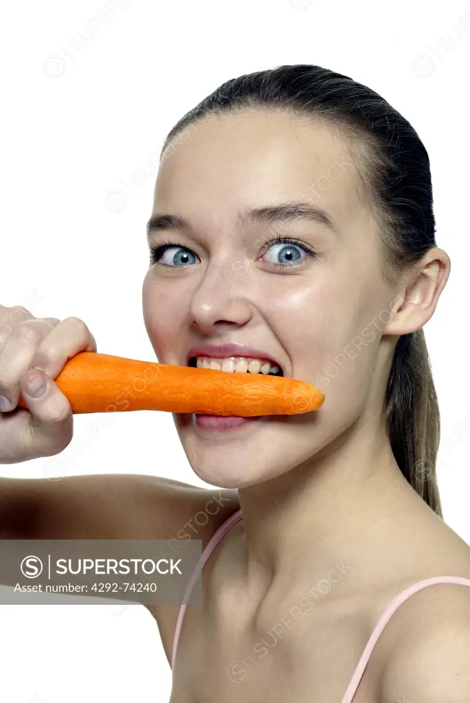 Woman biting a carrot