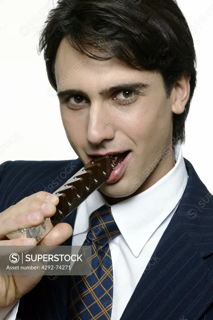 Man eating chocolate bar