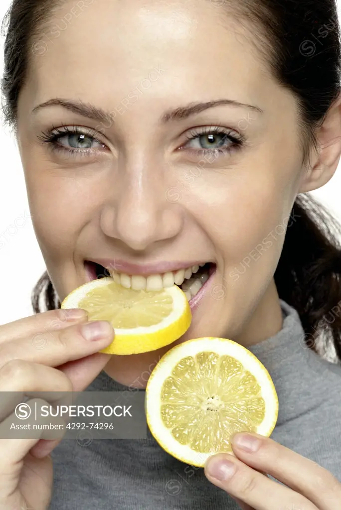 Woman eating lemon slice
