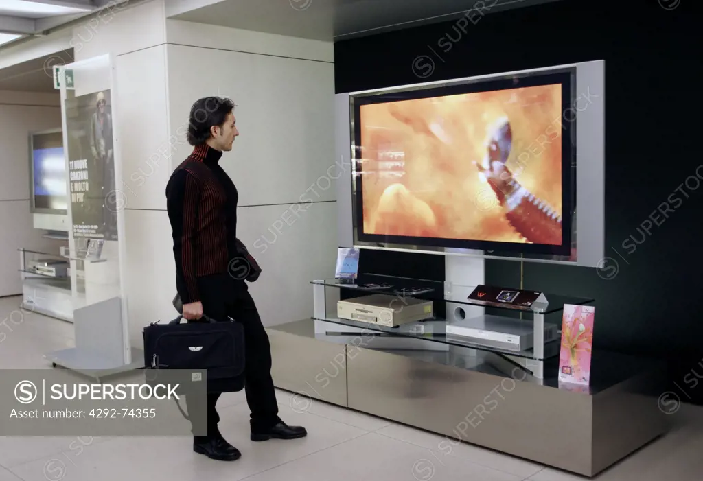 Man looking at big television screen (No Property Release)