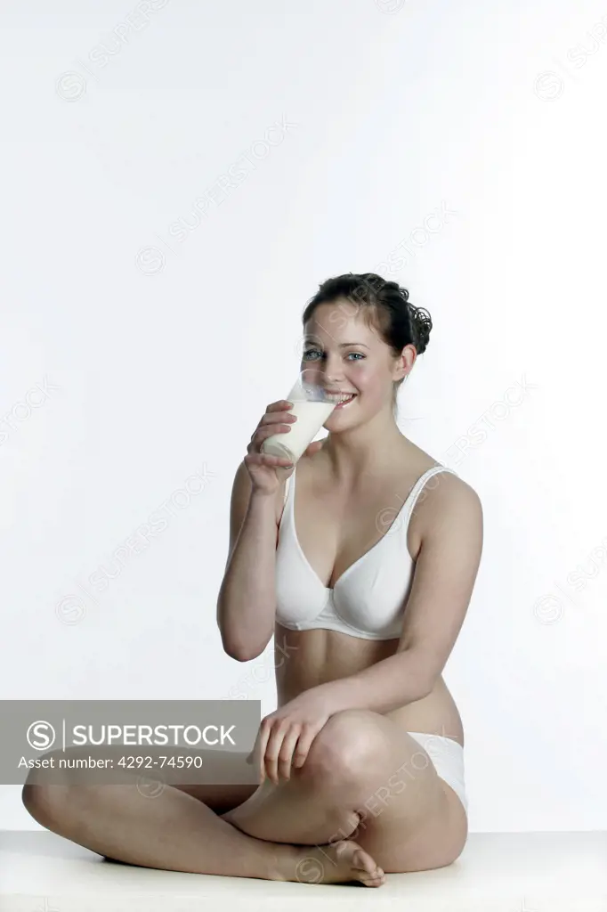 Overweight woman drinking a galss of milk