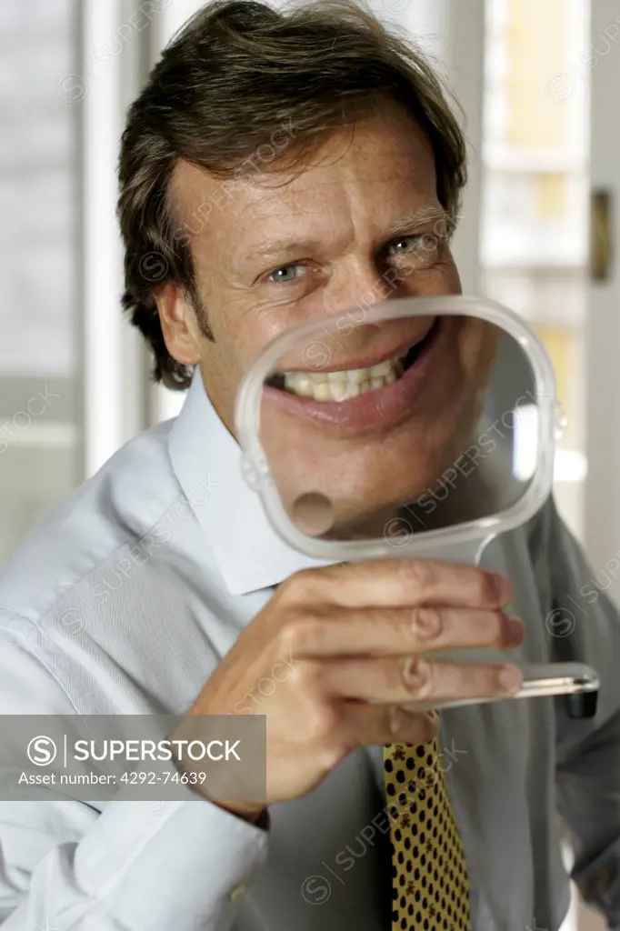 Man with magnifying glass on his mouth