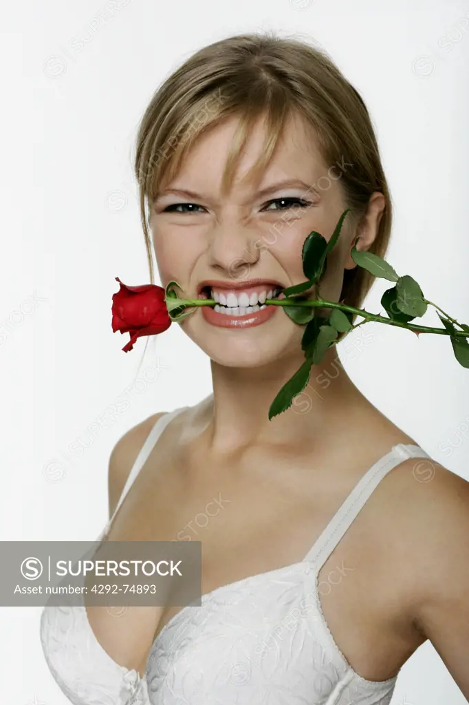 Woman with rose in teeth