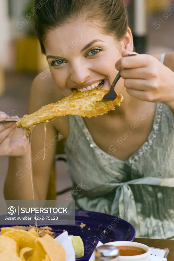 Woman eating chicken