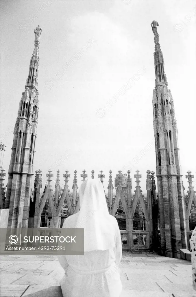 Milan. Nun sitting on the roof of the Duomo