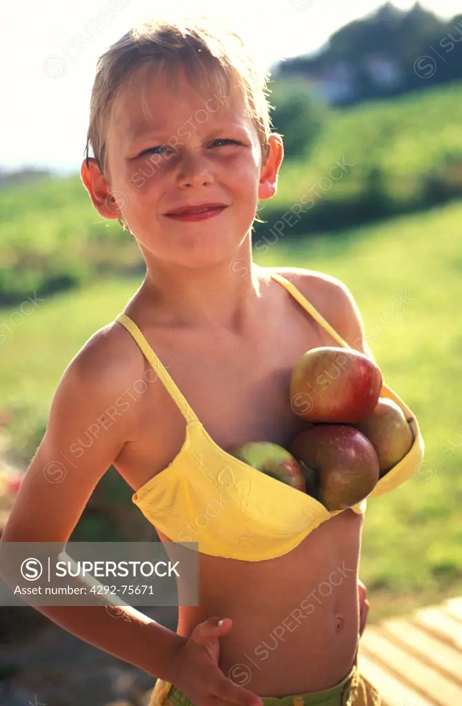 Boy wearing bra full of apples