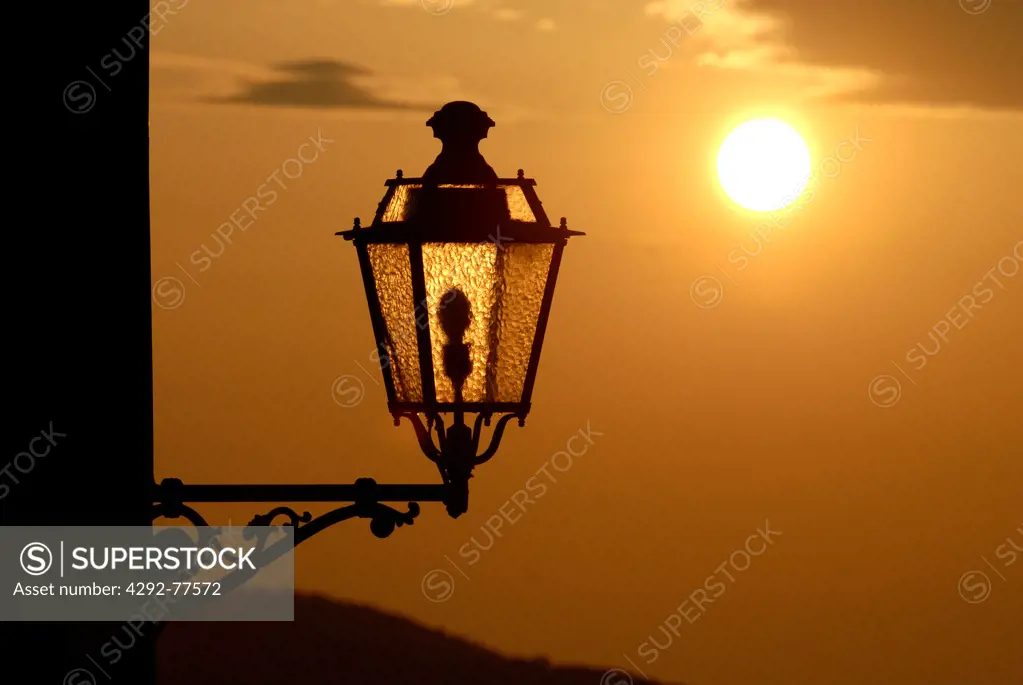 Italy, Liguria, Cinque Terre Tellaro.Street lamp close up and sunset over sea