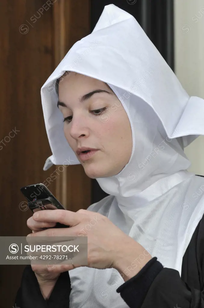 Young nun using mobile
