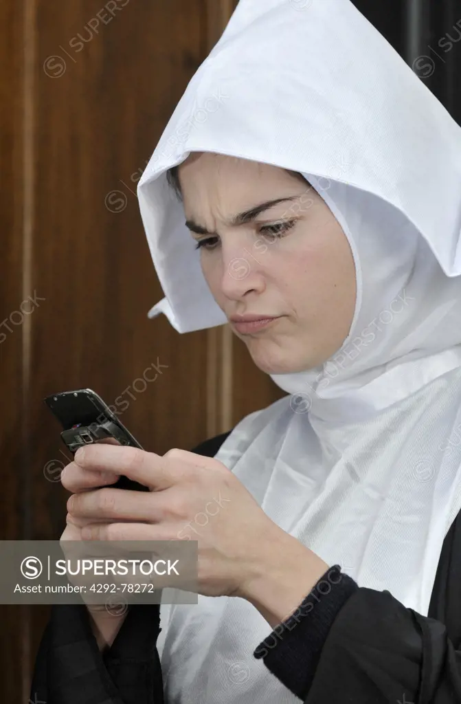 Young nun using mobile