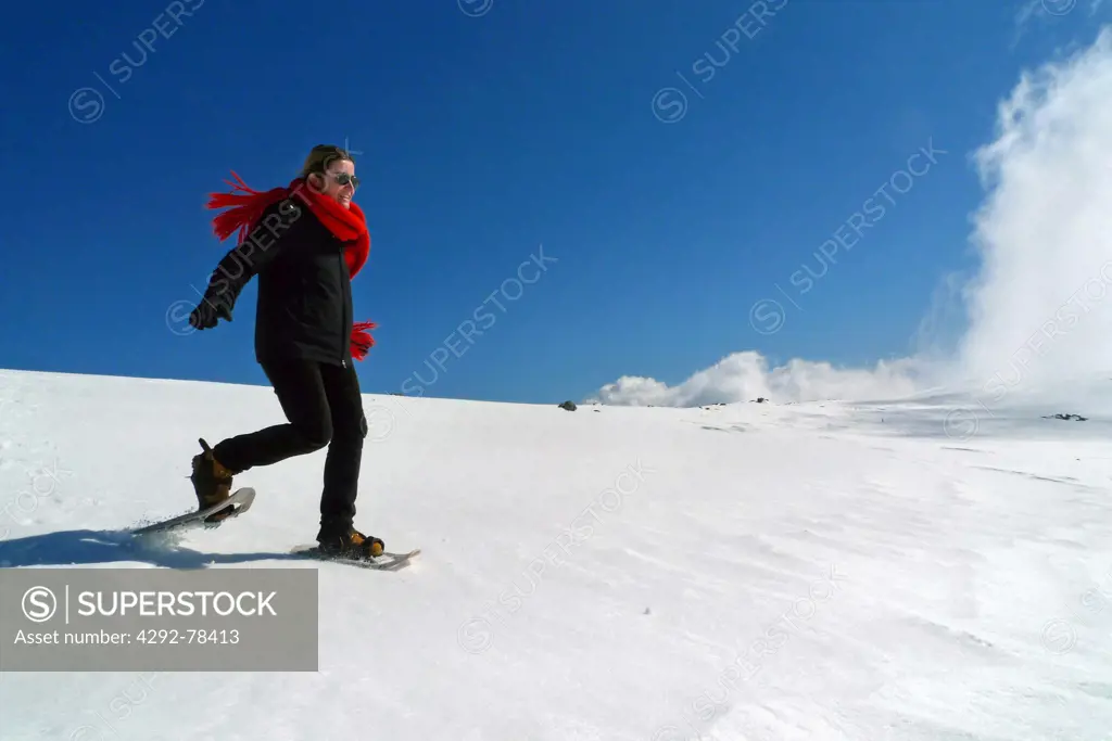 Italy, Liguria, Aiona Mountain, Woman snowshoeing
