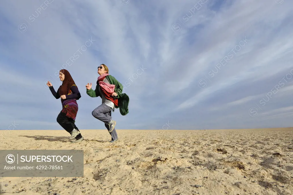 Iran, Yazd, Iranian Young People Running in the Desert