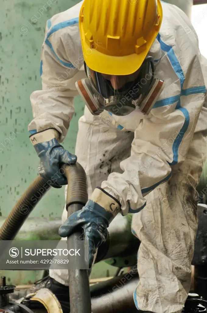 Man cleaning oil contaminated area