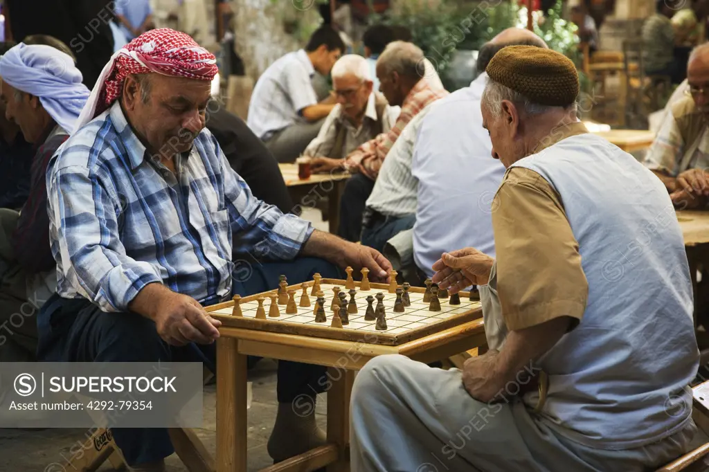 Turkey, Urfa, Bazaar, in the open court of a tea house, men play a variant of chess