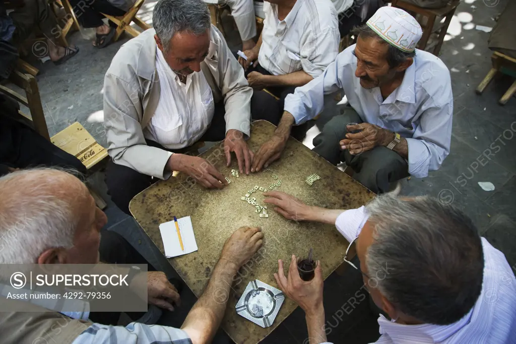 Turkey, Urfa, Bazaar, in the open court of a tea house, men play domino