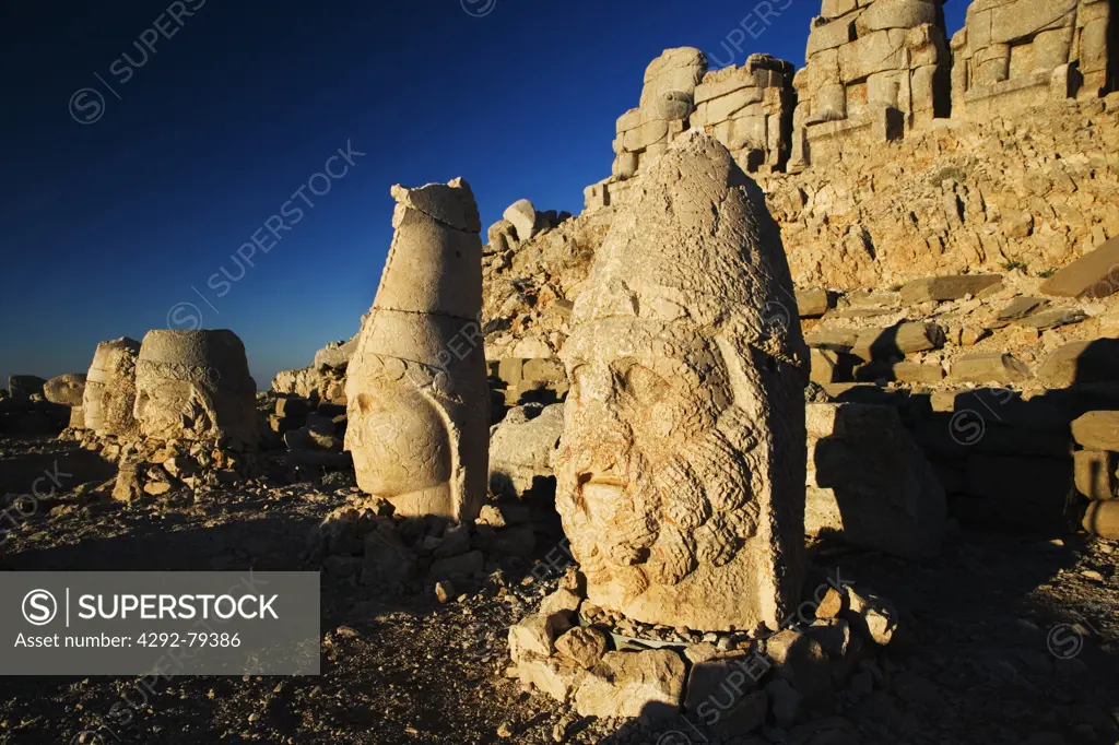 Turkey, Mount Nemrut Dagi, East terrace at sunrise, the colossal heads are, from L-R, Antiochus I, Tyche, Zeus-Oromasdes, Apollon-Helios and Heracles-Artagnes