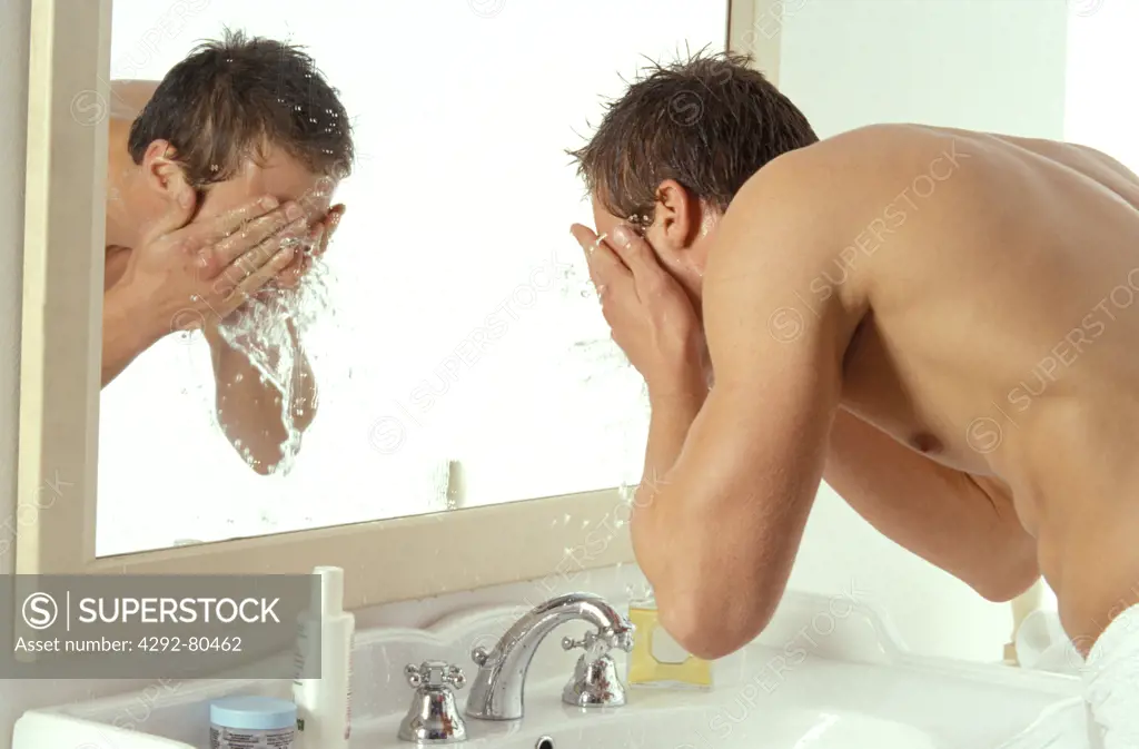 Man washing his face