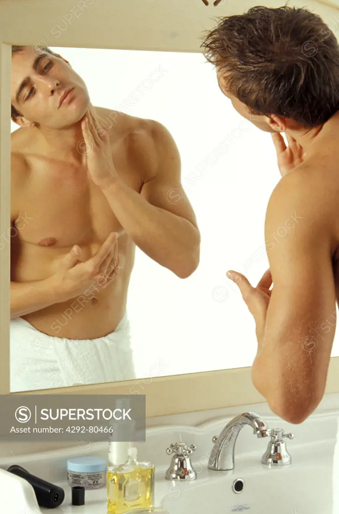 Man putting aftershave on