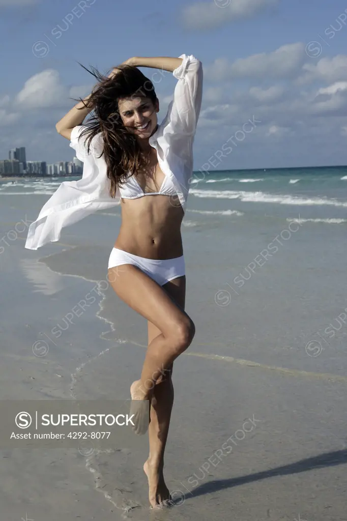 Young woman walking on beach