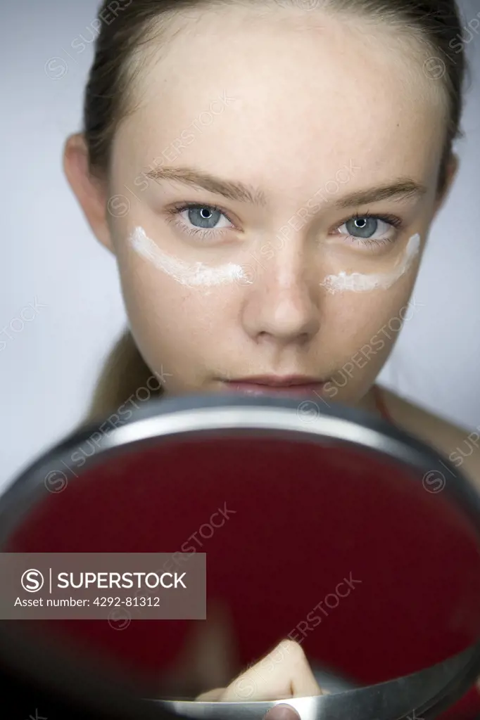 Woman's portrait with cream on her face