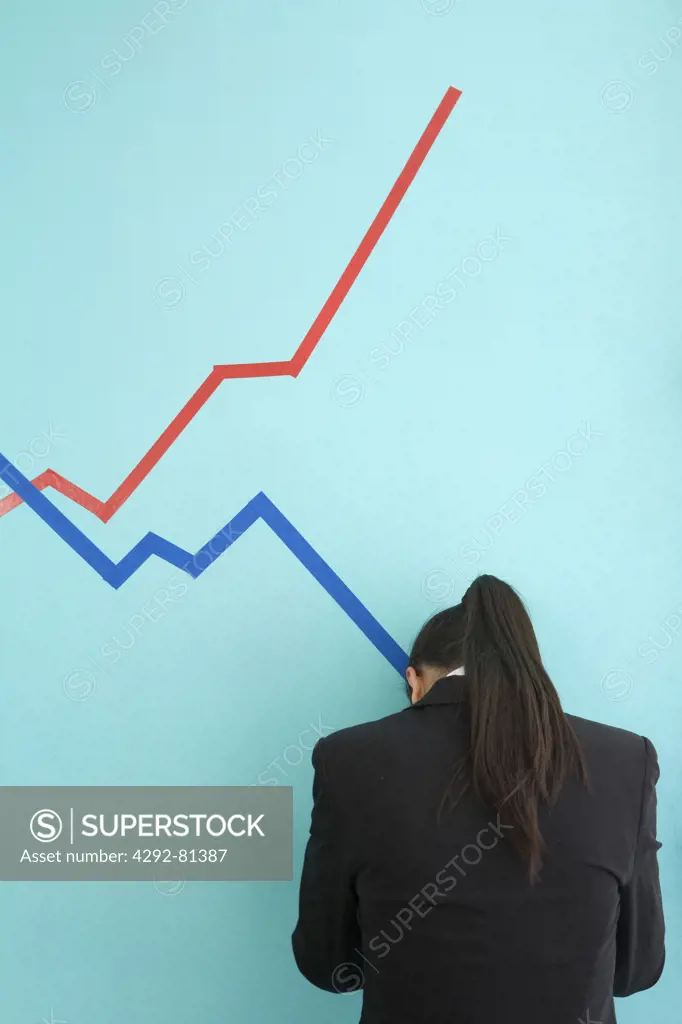 Desperate businesswoman in front of finance chart