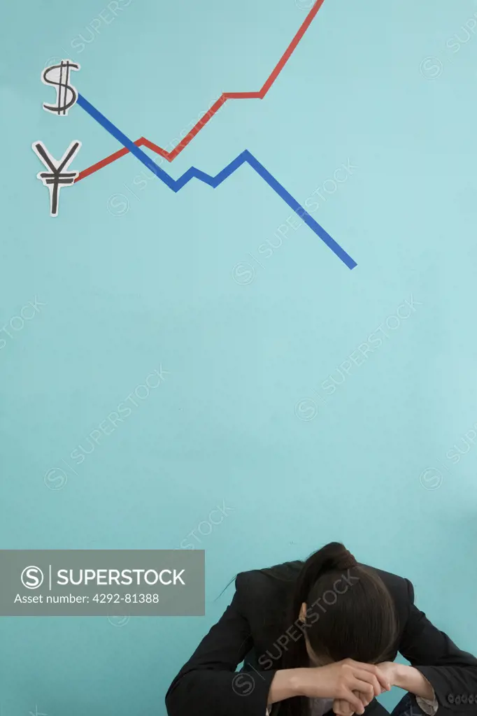 Desperate businesswoman behind a finance chart showing yen in loss