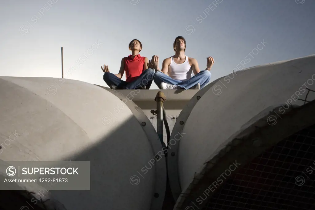 Multiethniccouple doing yoga