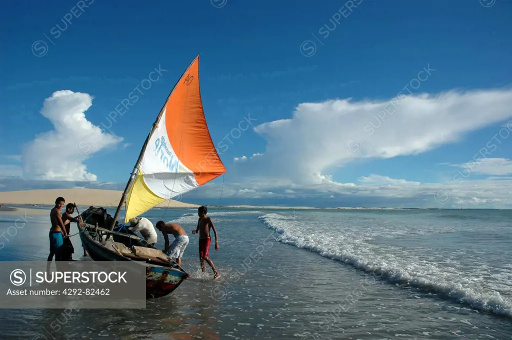 Brazil, Ceara State, Jericoacoara, Fishing Boat and Fishermen along the Beach