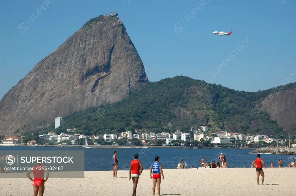 Brazil, Rio de Janeiro, Brazilians Playing Soccer at Praia do Flamengo the Pao de Acucar Sugar Loaf on the Background