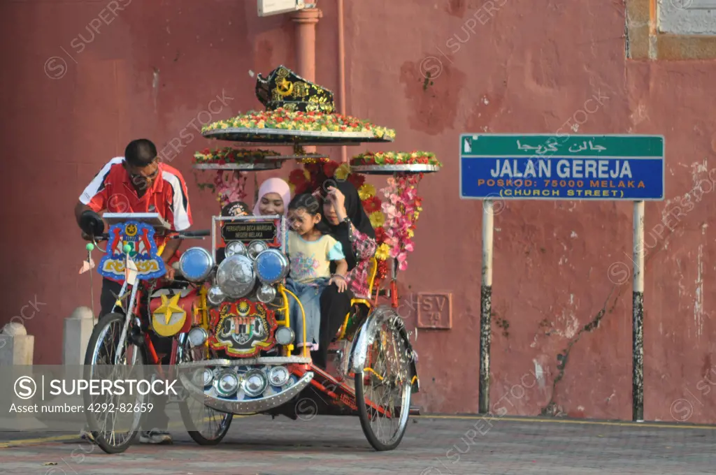 Malaysia, Malacca, Muslim family touring on a rickshaw in the Town Square