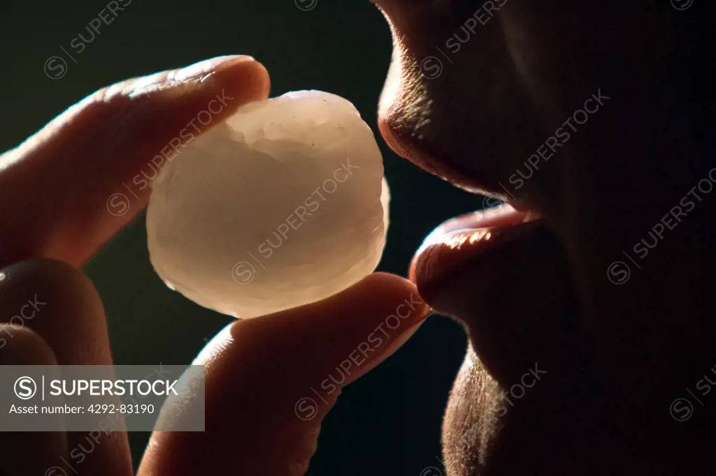 Man eating lychee