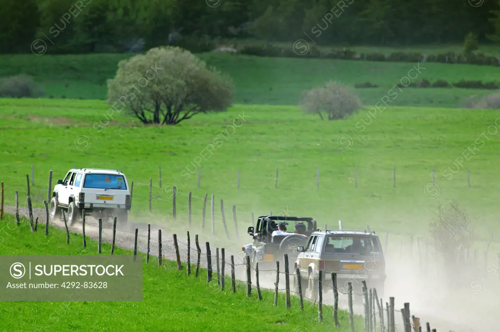 France, Auvergne, jeeps on dirt road