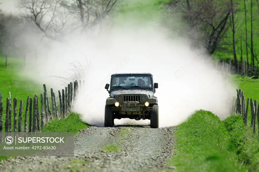 Jeep moving across dirt road