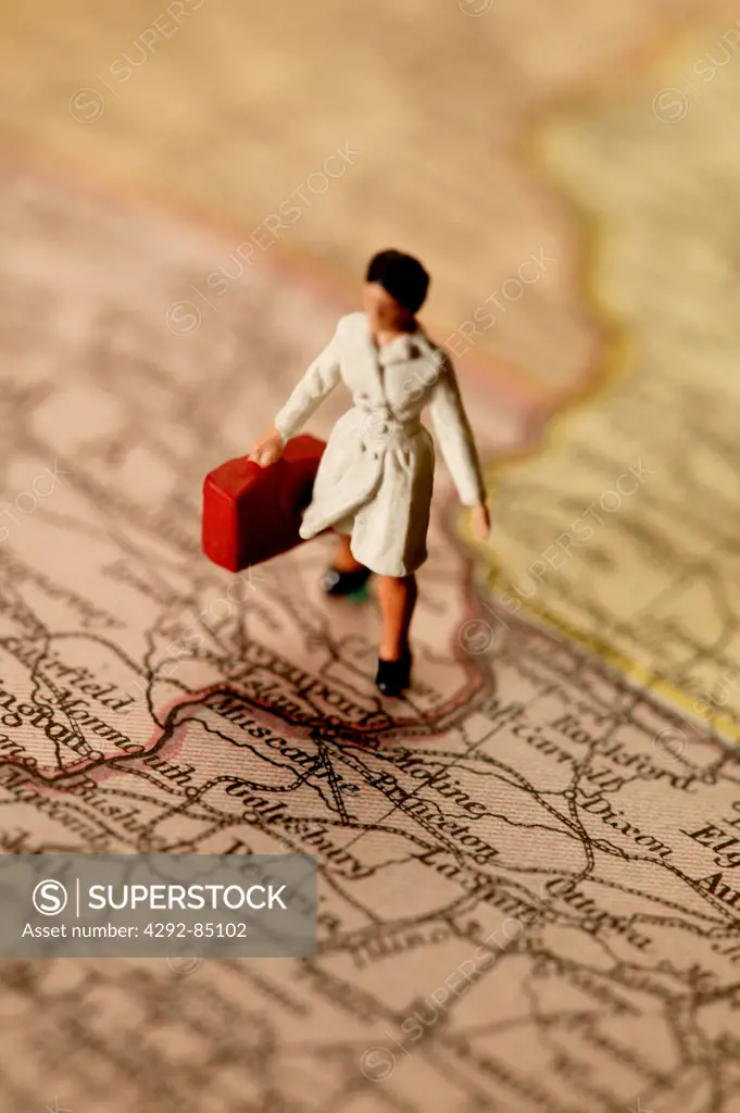 Figurine of a traveller on map