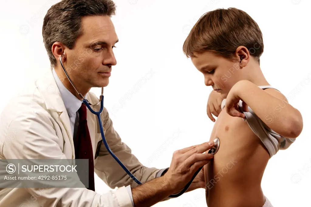 Doctor examining boy's chest