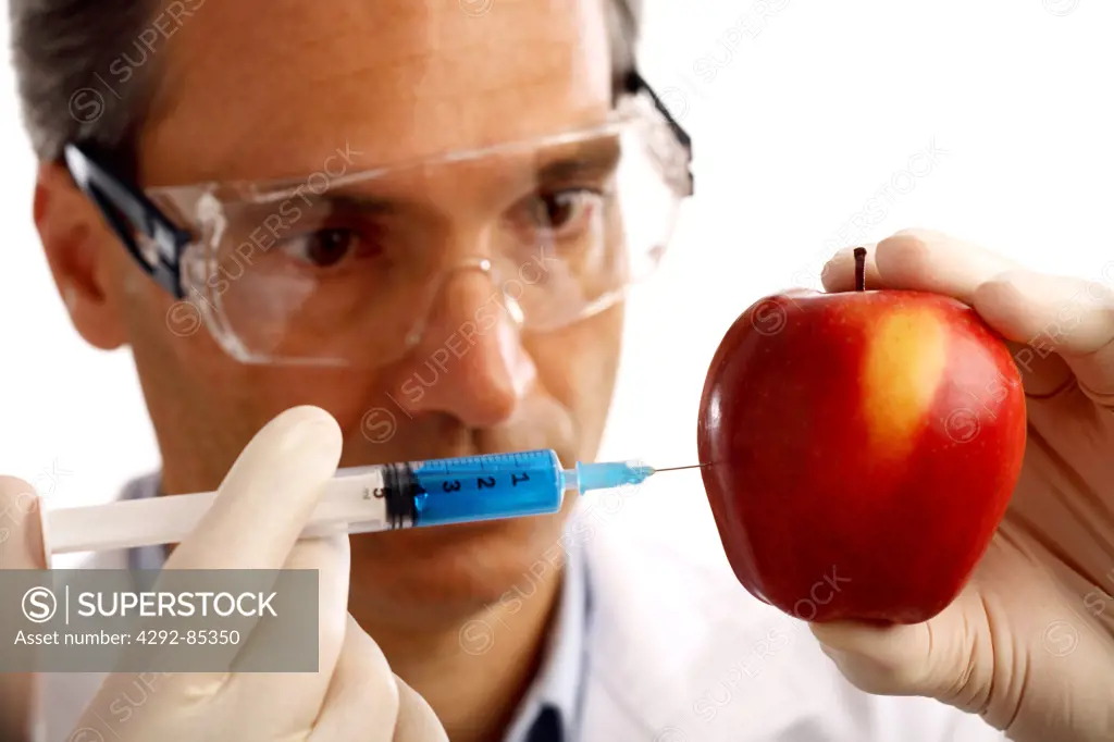 Apple being injected with a syringe