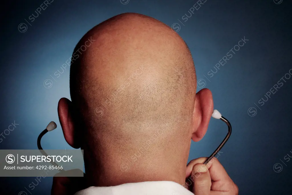 Rear view of a bald doctor wearing stethoscope