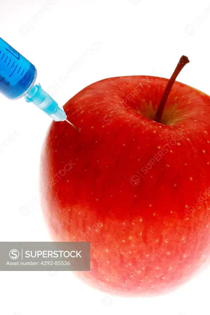 Apple being injected with a syringe