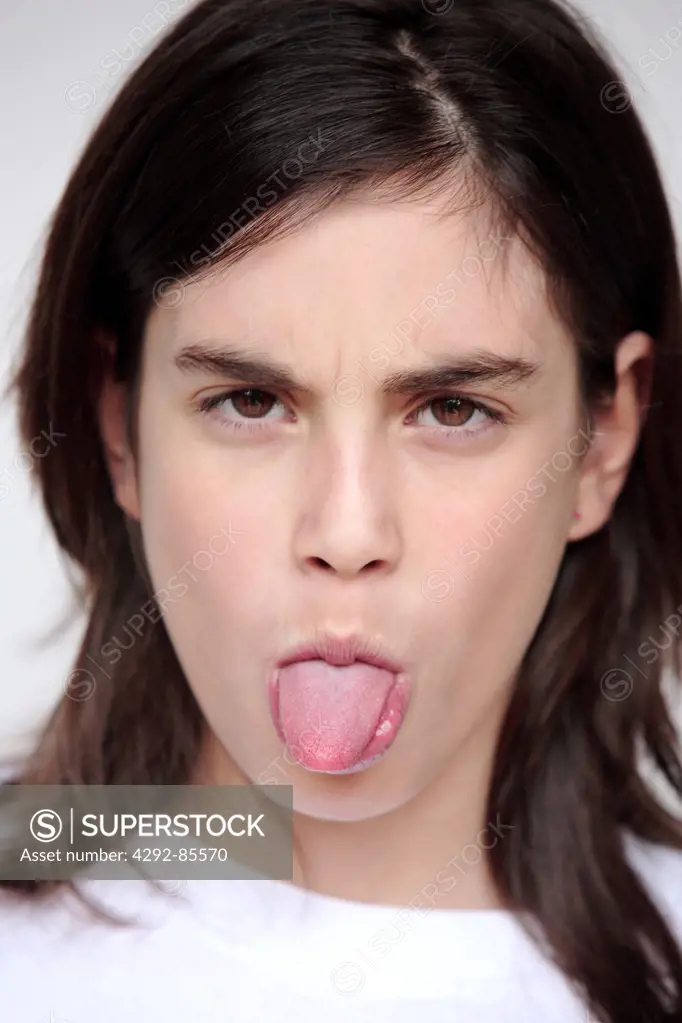 Portrait of a teenage girl sticking out tongue