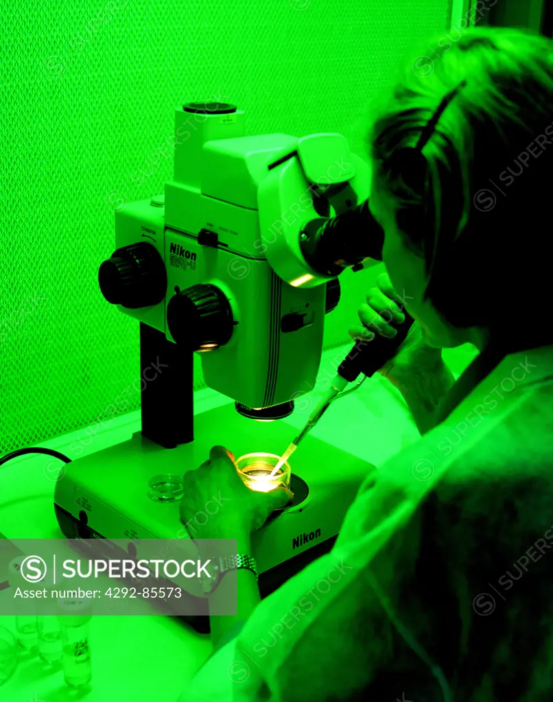 Lab researcher and microscope
