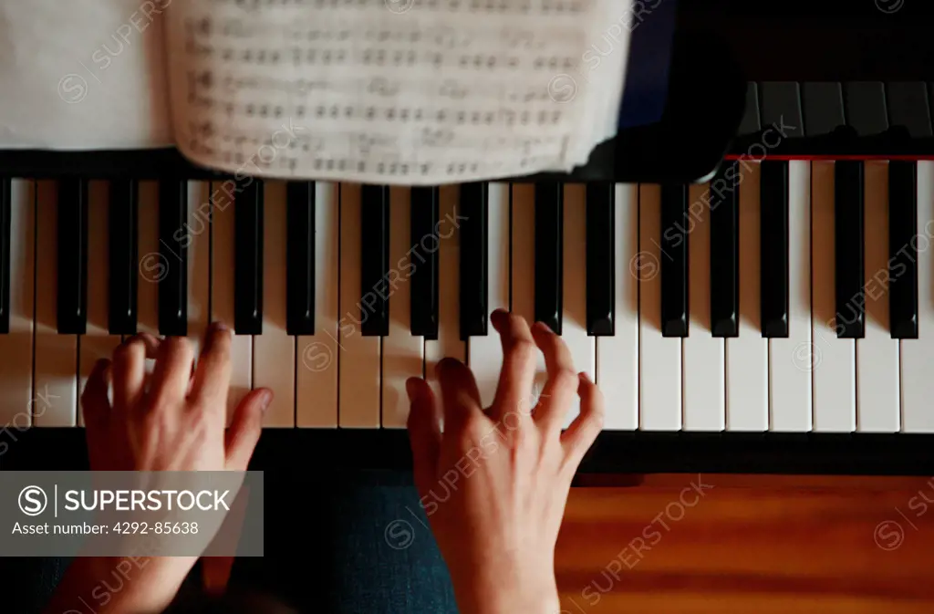 Playing piano, hands close up