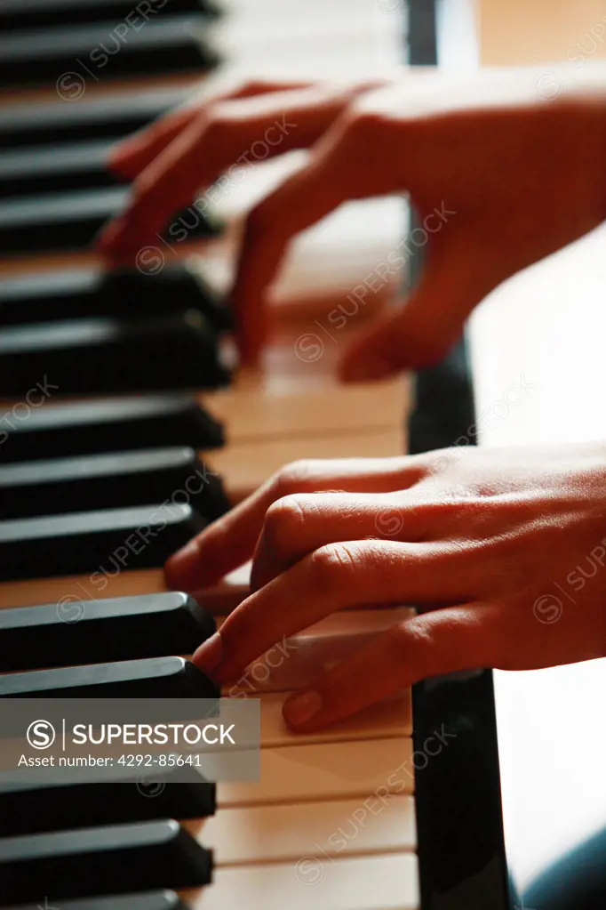 Playing piano, hands close up