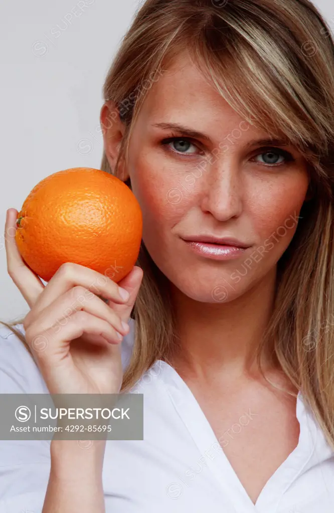Woman holding an orange
