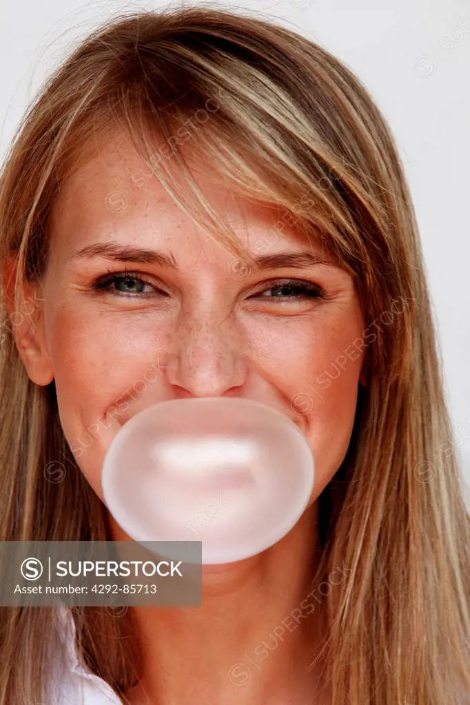 Woman blowing gum bubble